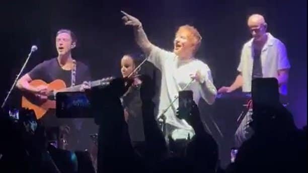 Beoga performing with Ed Sheeran during a live concert.